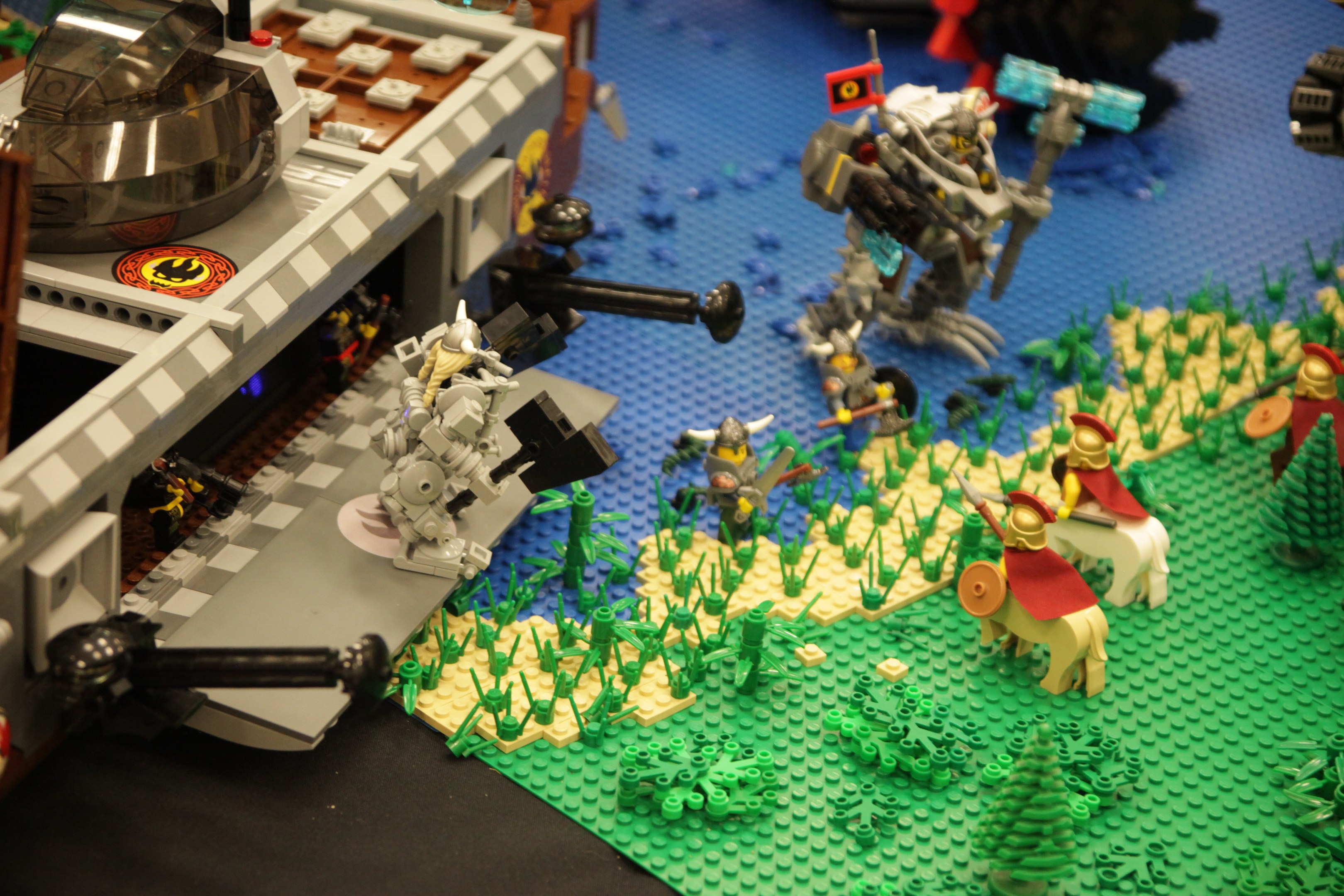 Ein Lego-Schlossmodell mit verschiedenen Lego-Teilen, darunter Spielzeuge, Pflanzen und andere Gegenstände, die auf seiner Oberfläche verstreut sind.