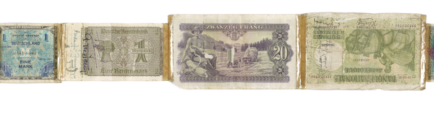 Ein altes Buch mit einem Stapel von verschiedenen Scheinen alter deutscher Banknoten darauf.