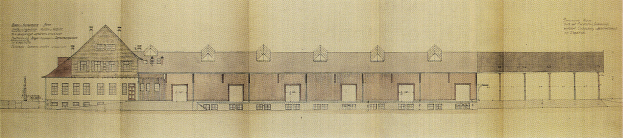 Ein detailliertes Gebäudeentwurf mit vielen Fenstern auf einem Blatt Papier mit begleitendem Text, das einen Lageplan für eine neue Schule darstellt.