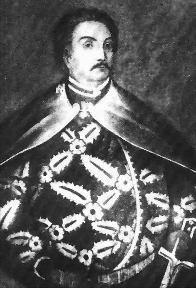 Schwarzes und weißes Foto von Papst Johannes Paul II. in Priesterrobe, der eine schwarze Robe mit weißem Kragen und Manschetten trägt und seine Hände verschränkt hält, mit ernster Miene und direktem Blick.